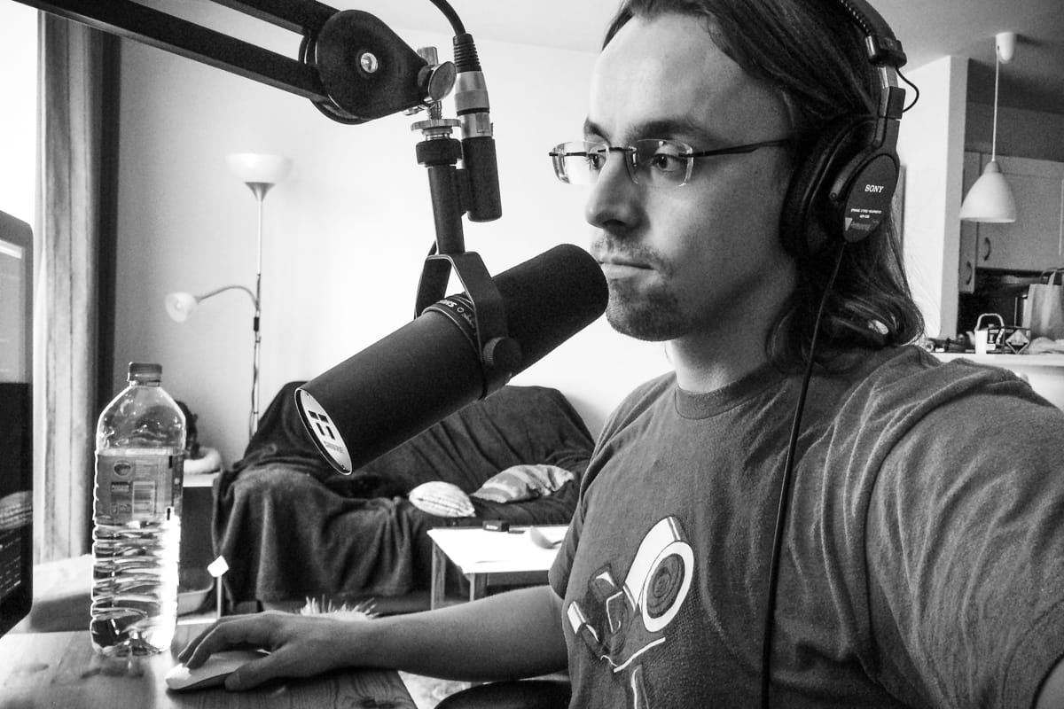 Profile picture of the author using Sony MDR 7506 monitor headphones and the Shure SM7B dynamic microphone.